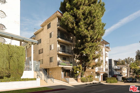 Front view of a multi-story residential building with balconies.