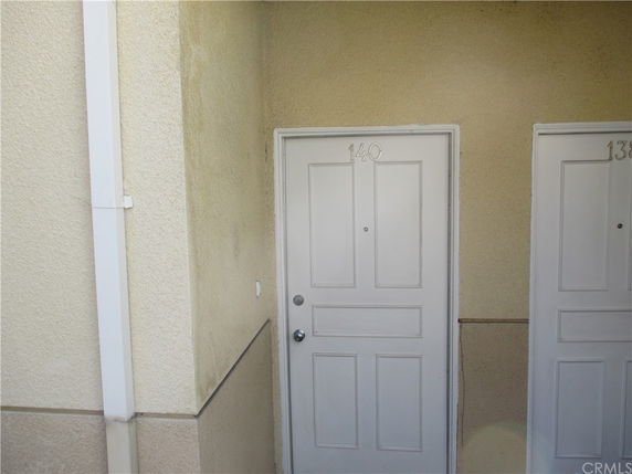View of a building entrance with two white doors marked 140 and 139.