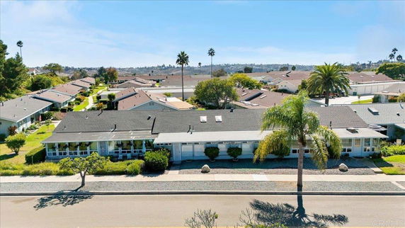 Front view of single-story residential buildings with gable roofs and large windows.