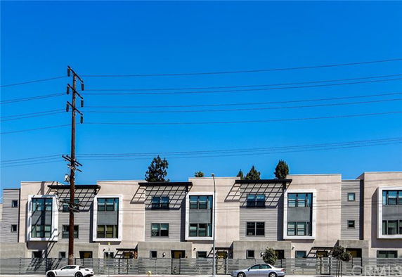 Front view of a modern multi-story building with large windows.
