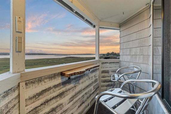 Balcony view overlooking coastal landscape.