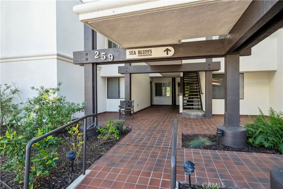 Front view of a condominium building with a covered entrance.