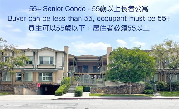 Front view of a senior condo building with beige exterior and multiple windows.