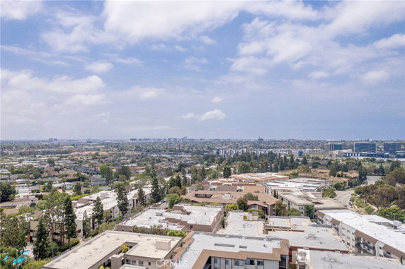 Panoramic view of a residential area with multiple buildings and distant cityscape.