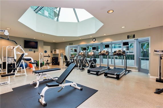 Indoor gym area with exercise equipment including treadmills and weight machines.