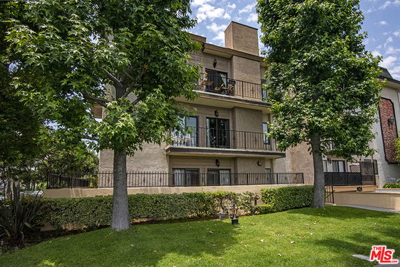 Front view of a multi-story residential building with balconies.