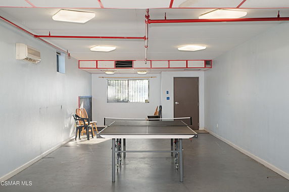 Indoor room with a table tennis setup and chair seating.