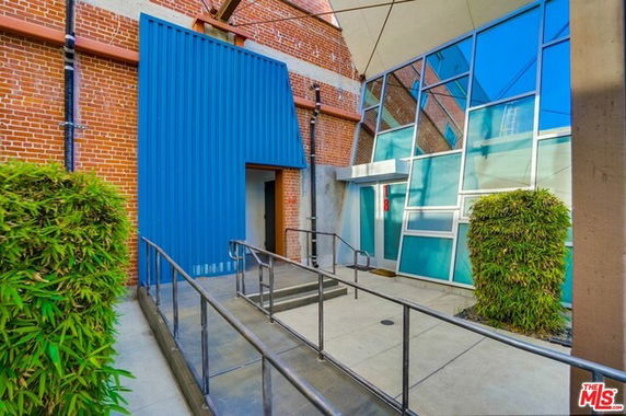 Front view of a building with a modern glass and brick design.