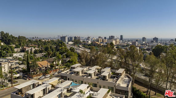 Panoramic view of a cityscape with multiple buildings under a clear sky.