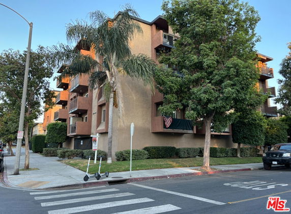 Front view of a multi-story residential building with balconies.