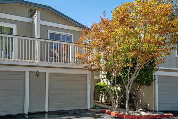 Front view of a house with two garages and a balcony.