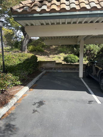 Outdoor parking area with a covered parking space.