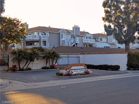 Front view of a multi-story residential building with balconies.