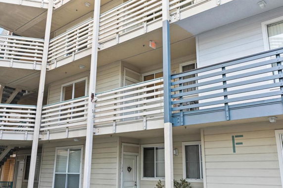 View of a multi-story apartment building with balconies.
