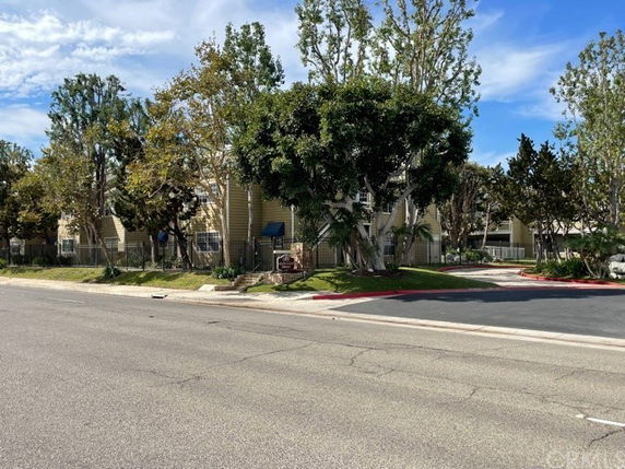 Front view of a residential building with trees in front.