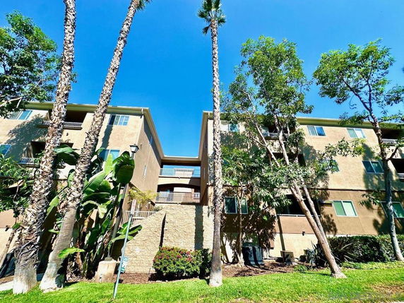 Front view of a multi-story apartment building with balconies.