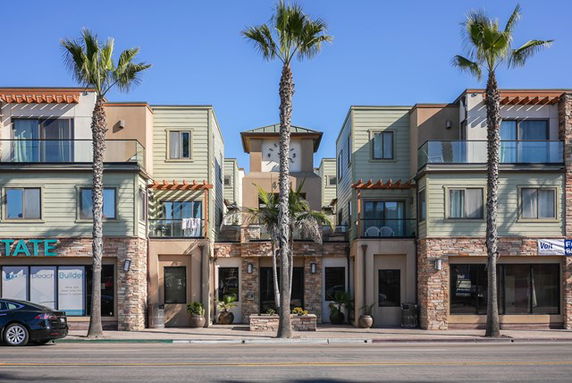 Front view of a multi-story building with modern architectural design.