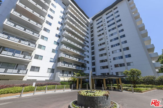 Front view of a multi-story residential building with balconies.