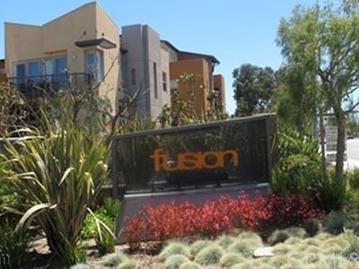 Front view of a modern multi-story building with the text 'fusion' on a sign in the foreground.