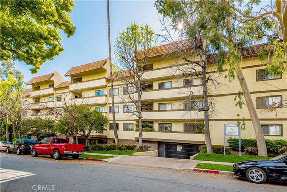 Front view of a multi-story residential building with balconies.