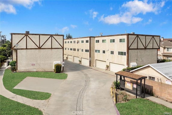 Front view of multi-story residential buildings with garage doors.