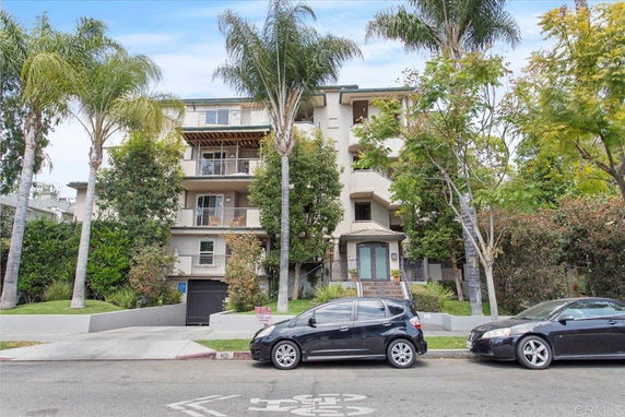 Front view of a multi-story residential building with balconies.