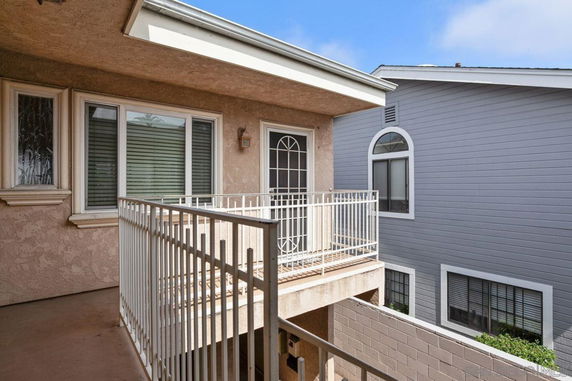 Outdoor view of a building with a balcony and railing.