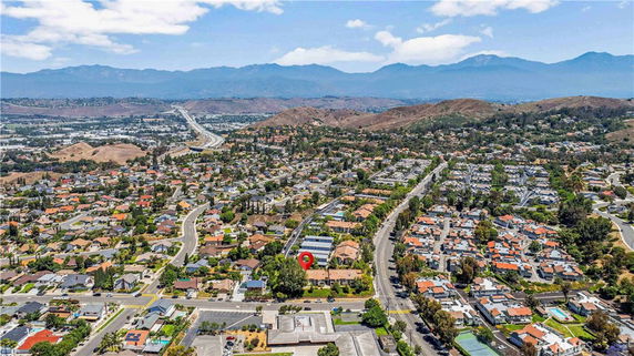 Panoramic view of a suburban neighborhood with distant mountains.