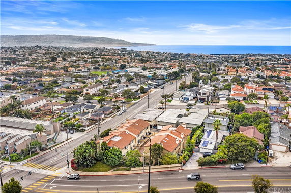 Wide-angle view of residential and coastal area seen from above.