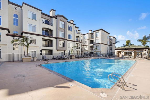 Swimming pool in front of a multi-story residential building.