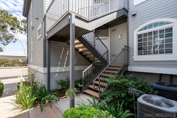 Side view of a multi-story building with exterior staircase