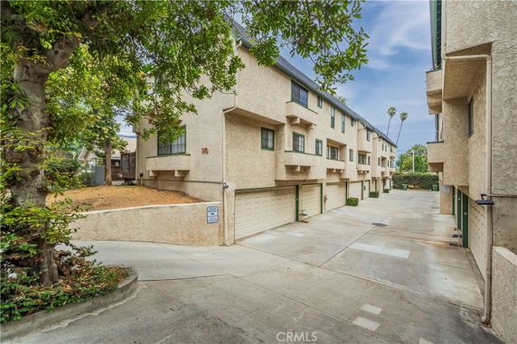 Front view of a multi-story residential building with multiple attached garages.