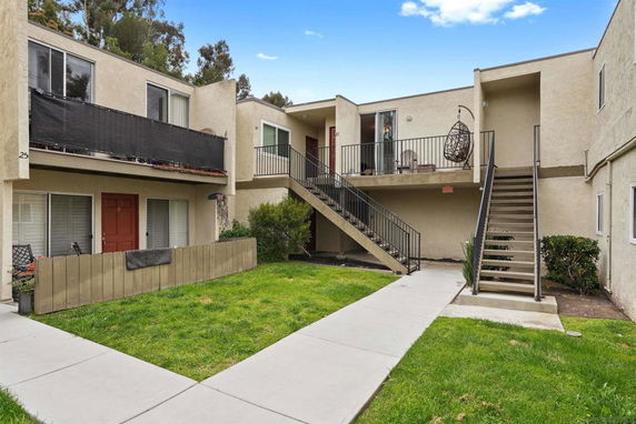 Front view of a two-story apartment building with exterior staircases.