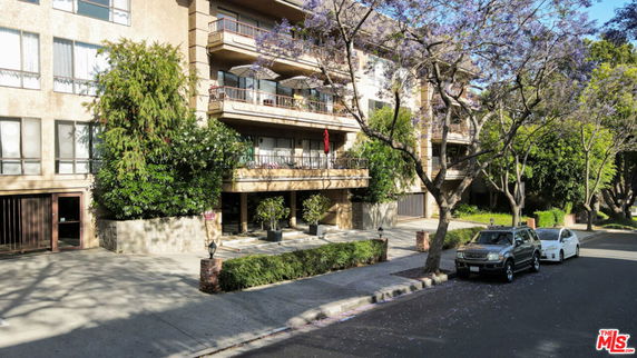 Front view of a multi-story apartment building with balconies.