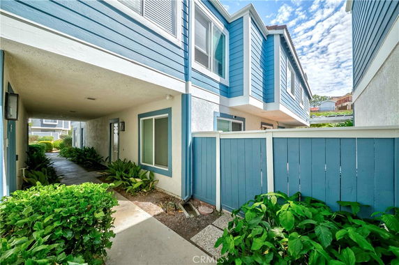 Front view of a two-story building with blue and white exterior walls.