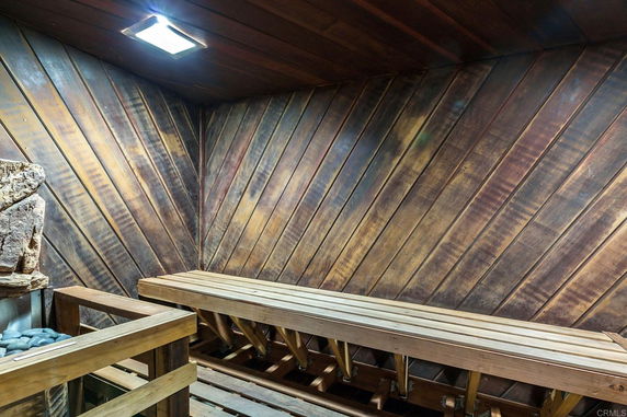 Interior view of a wooden sauna room with benches.