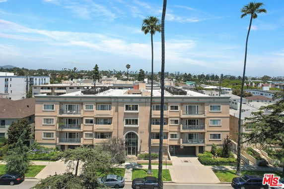 Front view of a multi-story apartment building with balconies.