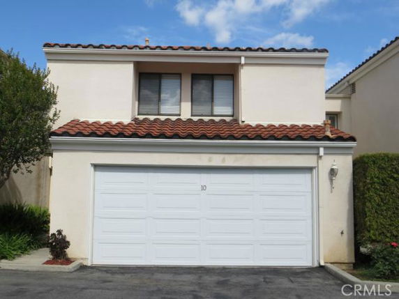 Front view of a two-story house with a double garage and tiled roof.