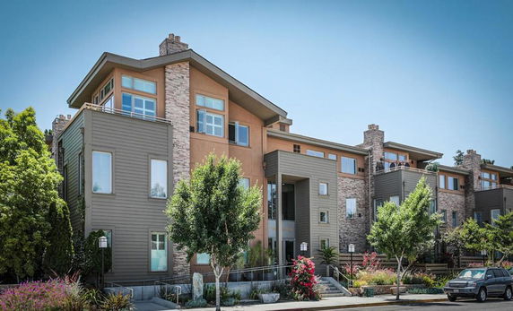 Front view of a multi-story residential building with modern design elements.