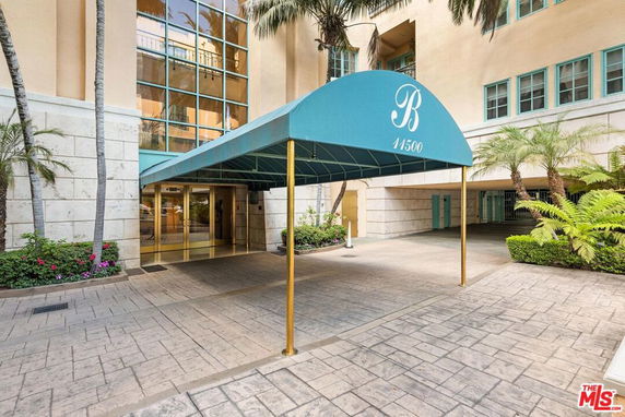 Front entrance of a building with a covered walkway.