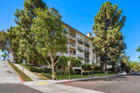 Front view of a multi-story residential building with balconies.