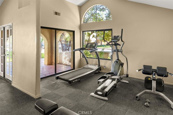 Indoor gym room with exercise equipment including treadmill and elliptical machine.