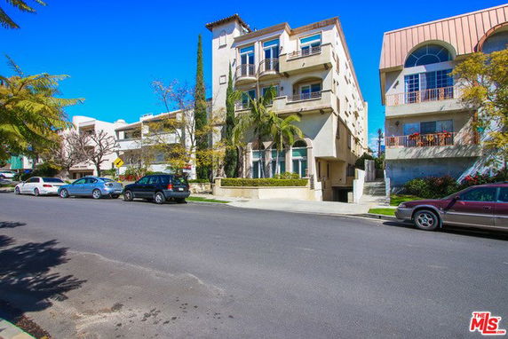 Front view of a multi-story building with balconies.