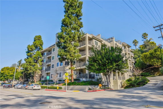 Front view of a multi-story apartment building with balconies.