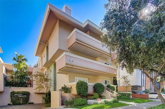Front view of a multi-story residential building with balconies.