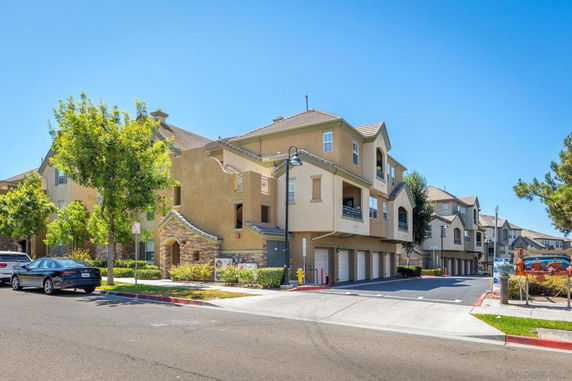 Front view of a multi-story residential building with attached garages.