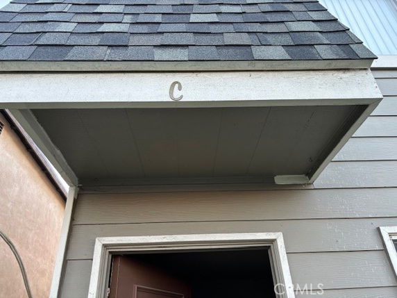 Front view of a building entrance with a letter C above the door.
