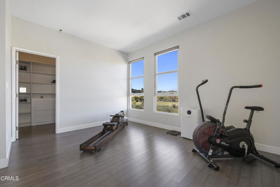 Room equipped with exercise equipment and a large window.