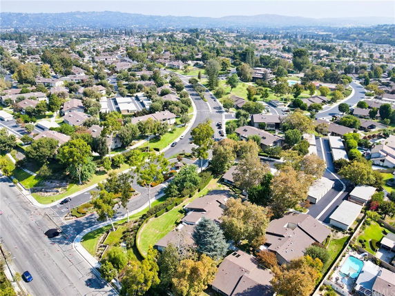 Aerial view of a residential neighborhood with houses and greenery.
