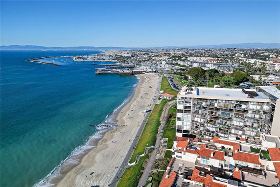 Panoramic view of a beachside city with buildings and coastline.